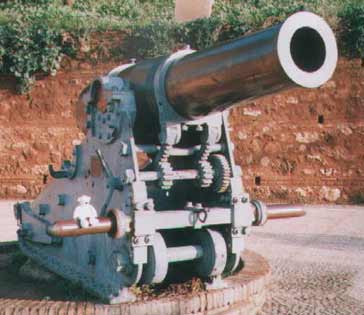 Paddy sitting on a Large Gun in Spain